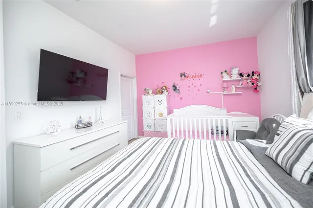 a bedroom with a bed and a flat screen tv