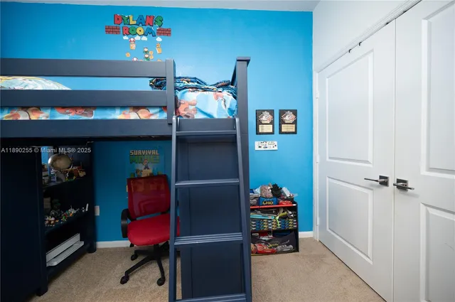 a view of a bedroom with wooden floor and a window