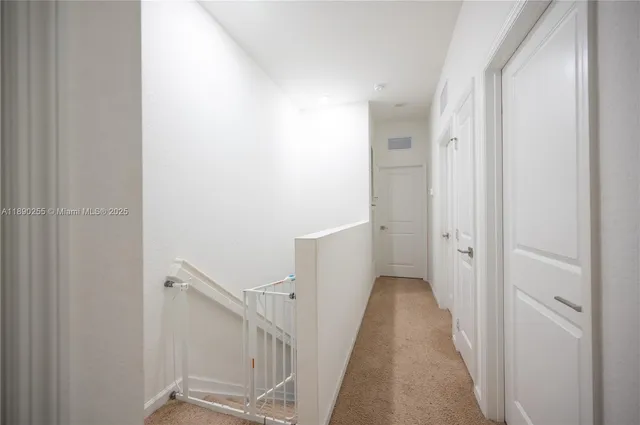 a white toilet sitting next to a white wall