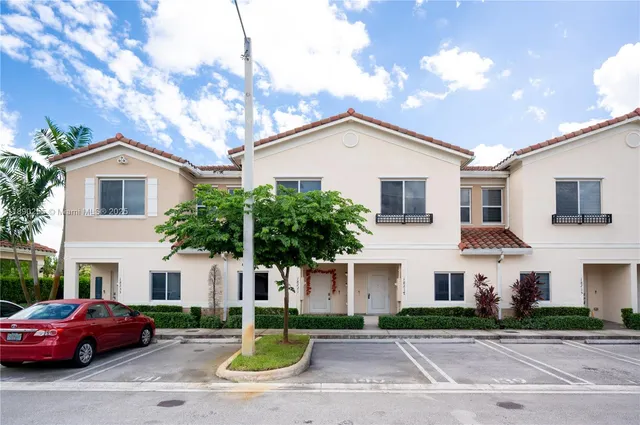 a front view of a house with a garden and plants