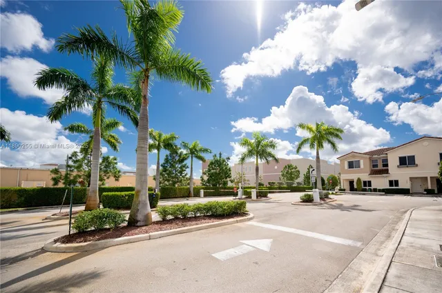 a view of a street with a cars park side of a road