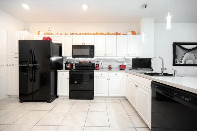 a kitchen with stainless steel appliances a stove refrigerator sink and microwave
