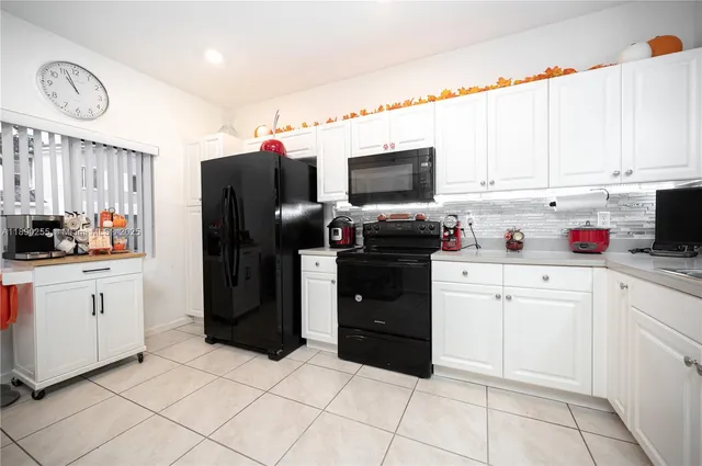 a kitchen with cabinets and appliances