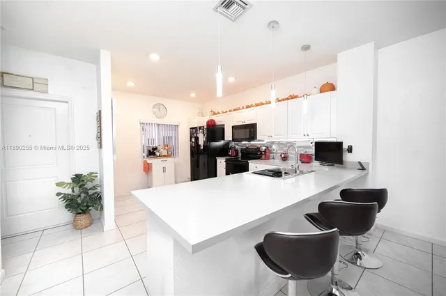 a large kitchen with a table and chairs