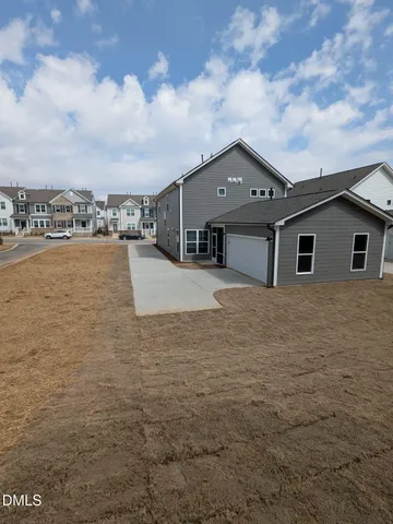 a view of house with yard and ocean view