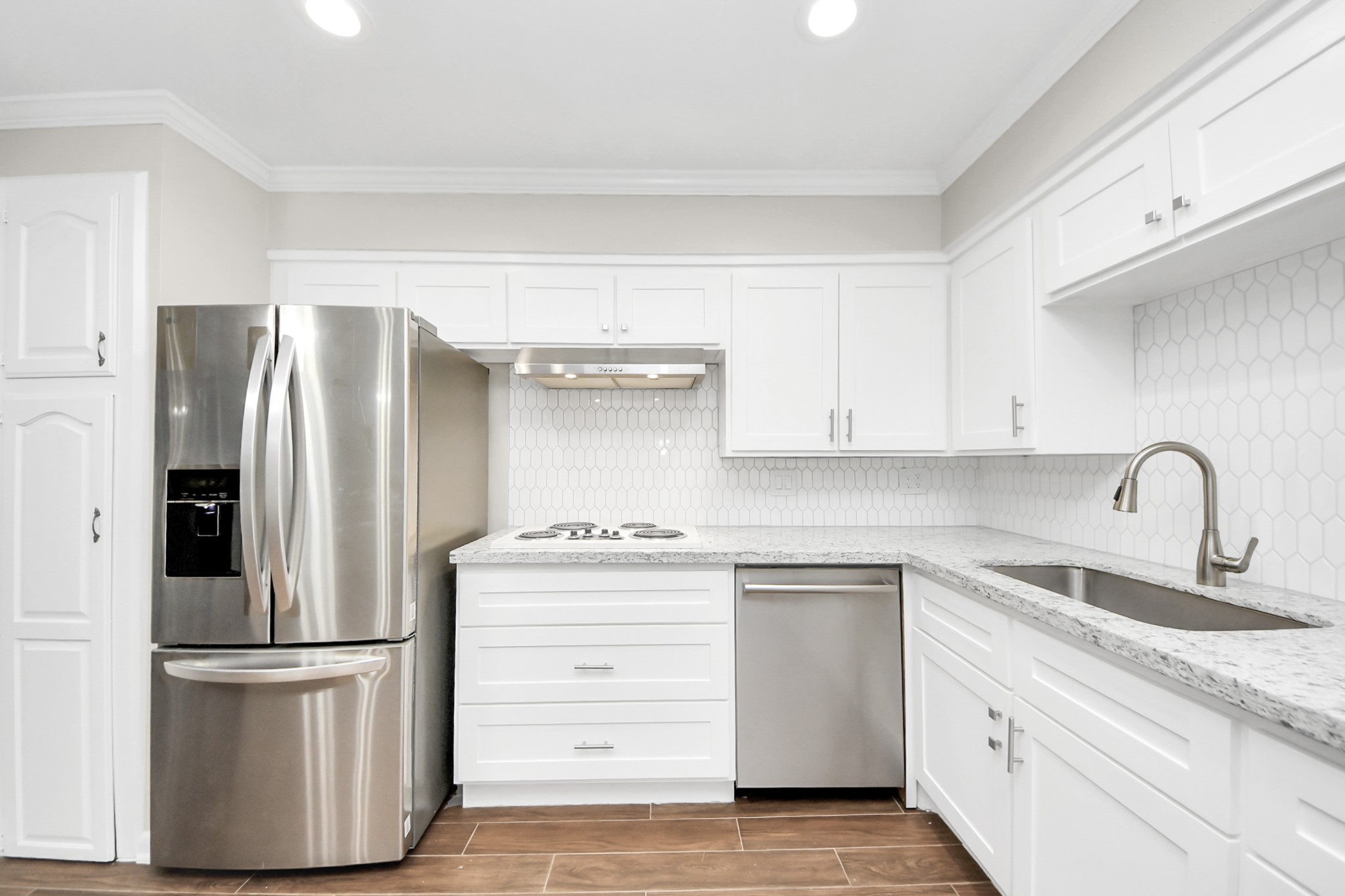 8234 Fondren Road, Unit 8234 Houston, TX 77074 - Photo 1 of 10 a kitchen with a refrigerator sink and white cabinets