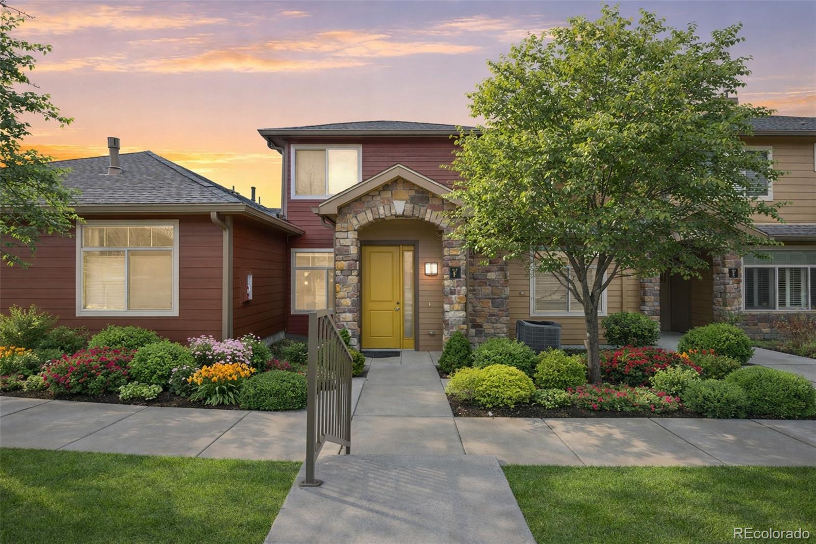 8615 Gold Peak Place, Unit F Highlands Ranch, CO 80130 - Photo 1 of 39 a front view of a house with a yard