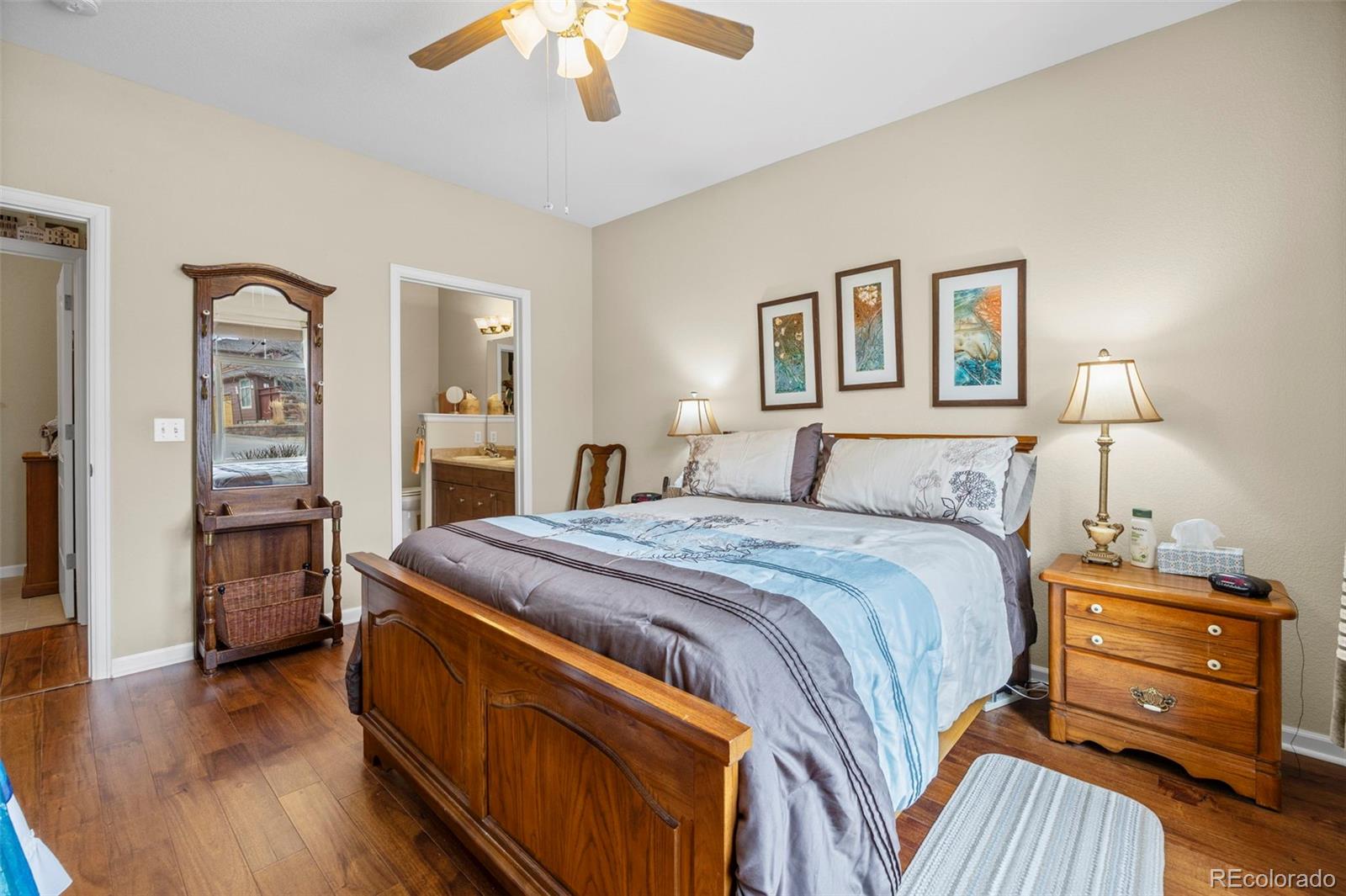 8615 Gold Peak Place, Unit F Highlands Ranch, CO 80130 - Photo 13 of 39 a bedroom with a bed and a chandelier