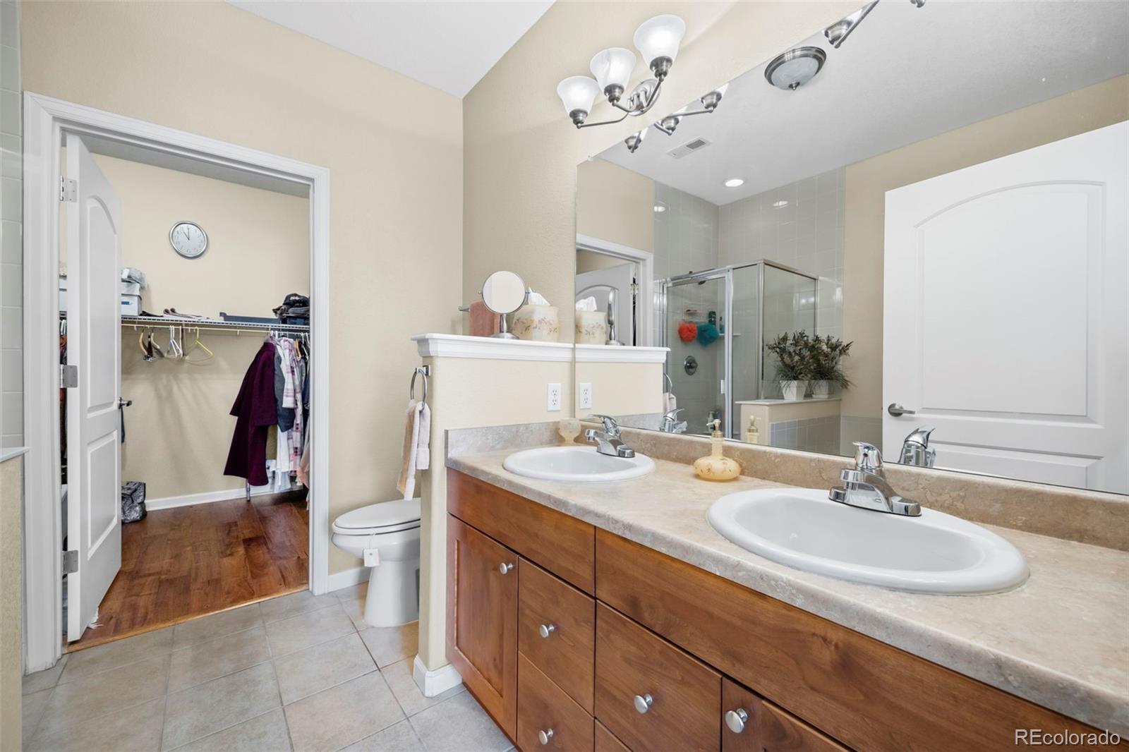 8615 Gold Peak Place, Unit F Highlands Ranch, CO 80130 - Photo 14 of 39 a bathroom with a sink double vanity and a mirror