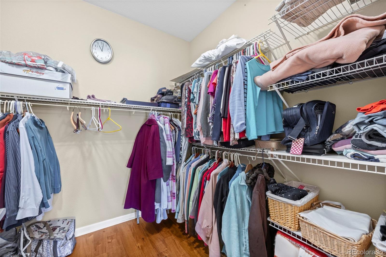 8615 Gold Peak Place, Unit F Highlands Ranch, CO 80130 - Photo 16 of 39 a view of walk in closet with clothes and shoes