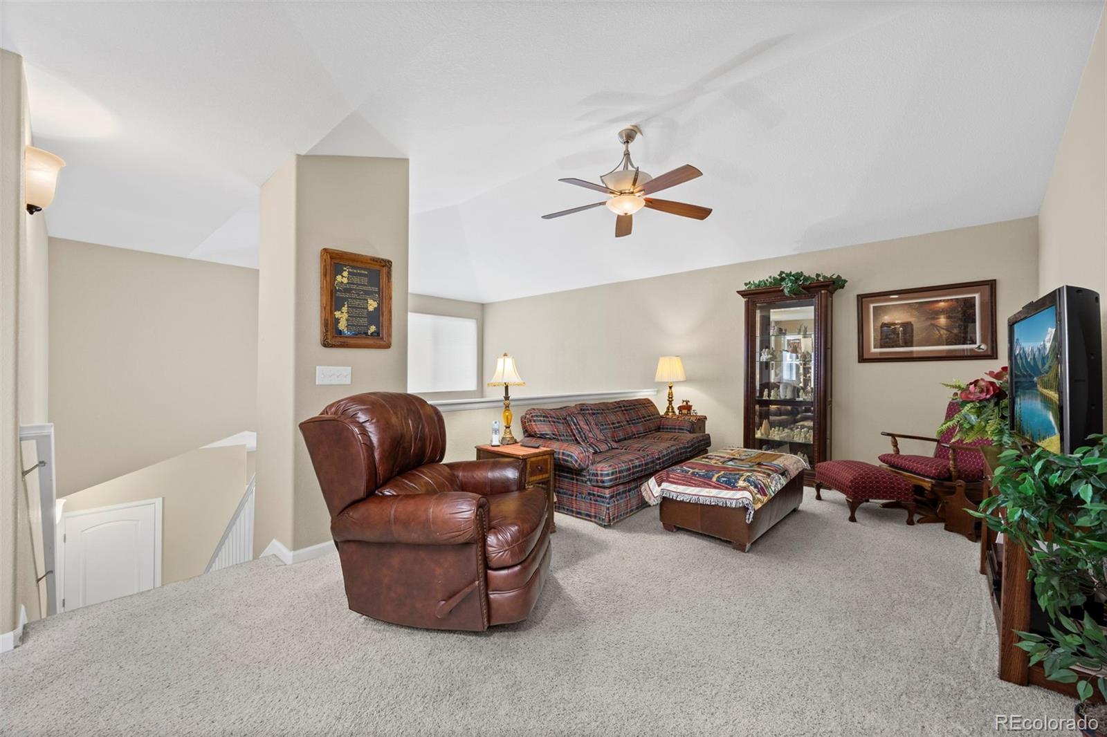 8615 Gold Peak Place, Unit F Highlands Ranch, CO 80130 - Photo 17 of 39 a living room with furniture flowerpot and a window