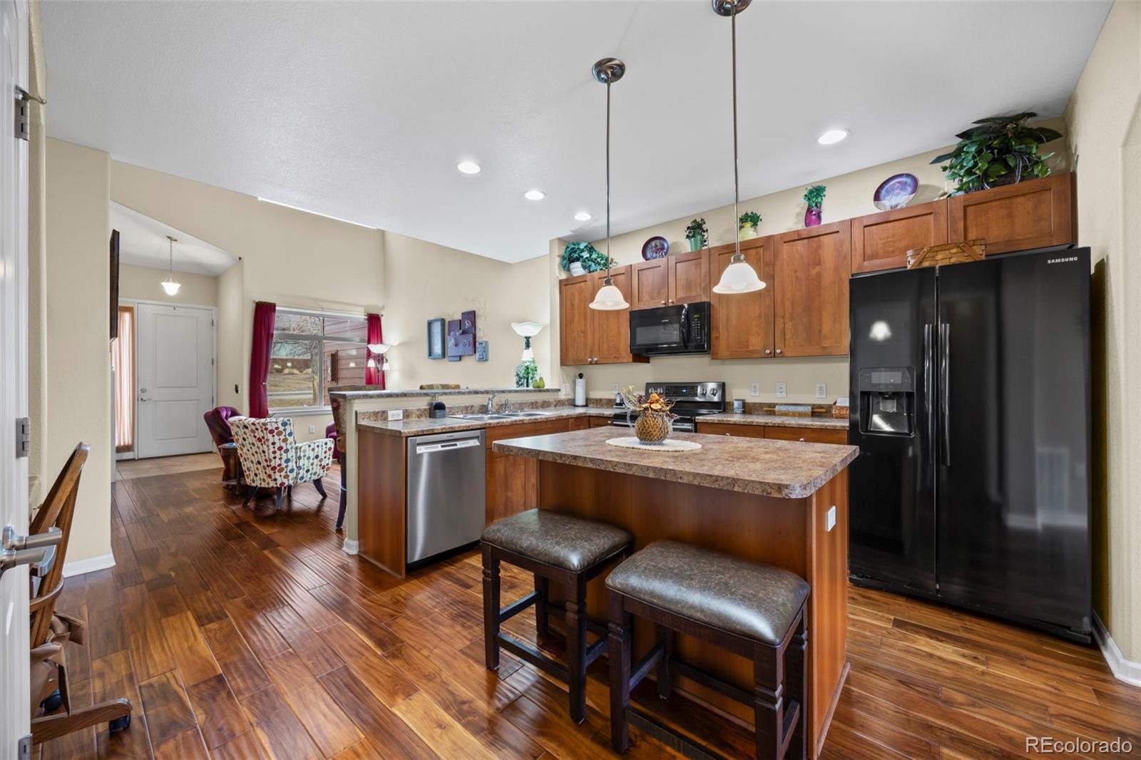 8615 Gold Peak Place, Unit F Highlands Ranch, CO 80130 - Photo 2 of 39 a kitchen with a sink appliances and wooden floor