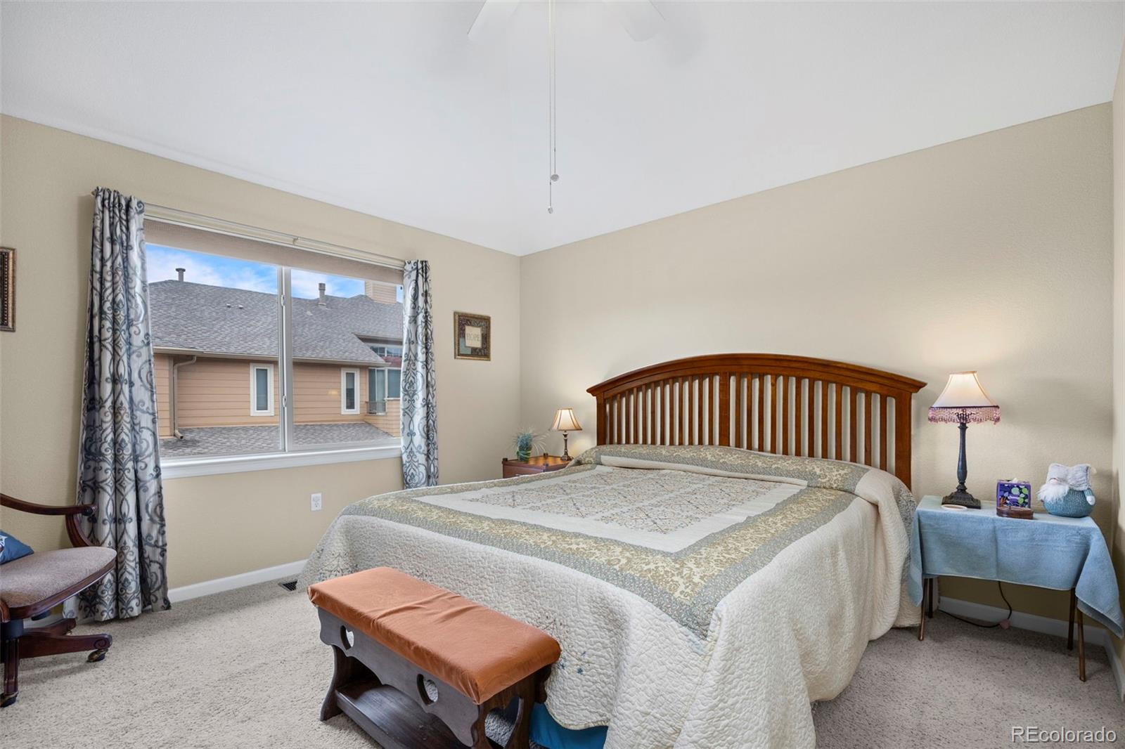 8615 Gold Peak Place, Unit F Highlands Ranch, CO 80130 - Photo 21 of 39 a bedroom with a bed and a dresser in it