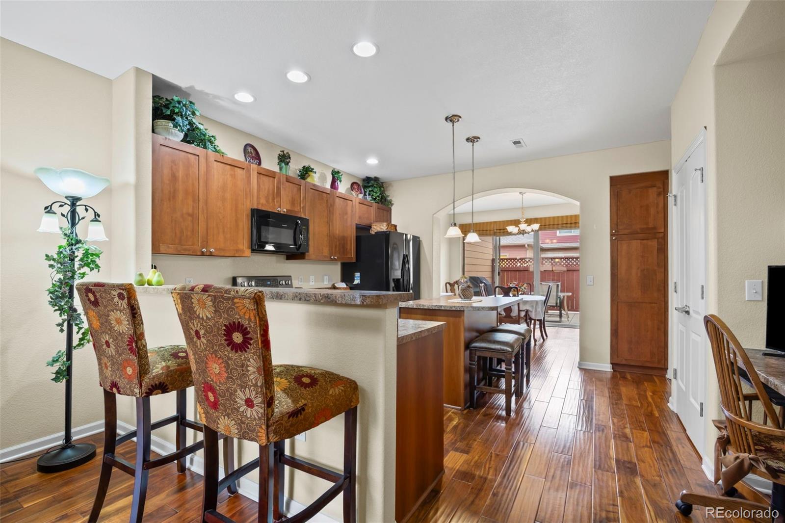 8615 Gold Peak Place, Unit F Highlands Ranch, CO 80130 - Photo 4 of 39 a view of a dining room with furniture and wooden floor