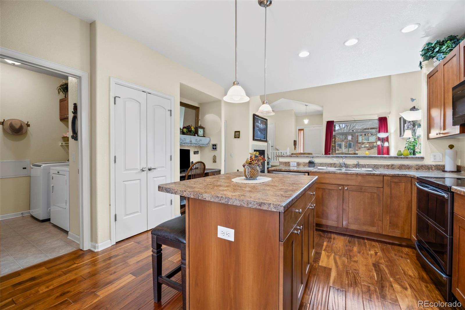8615 Gold Peak Place, Unit F Highlands Ranch, CO 80130 - Photo 5 of 39 a kitchen with stainless steel appliances granite countertop a sink a stove and a refrigerator