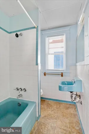 a bathroom with a window and a shower