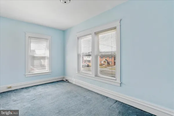 a view of a city street and houses