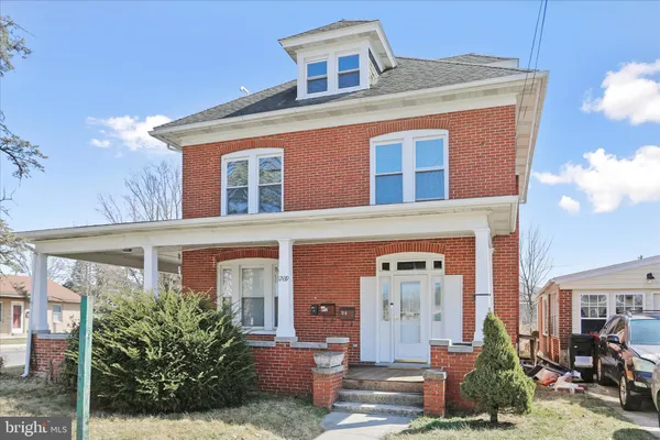 front view of a brick house with a large windows