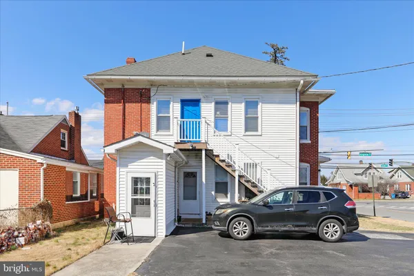 a front view of a house with parking space