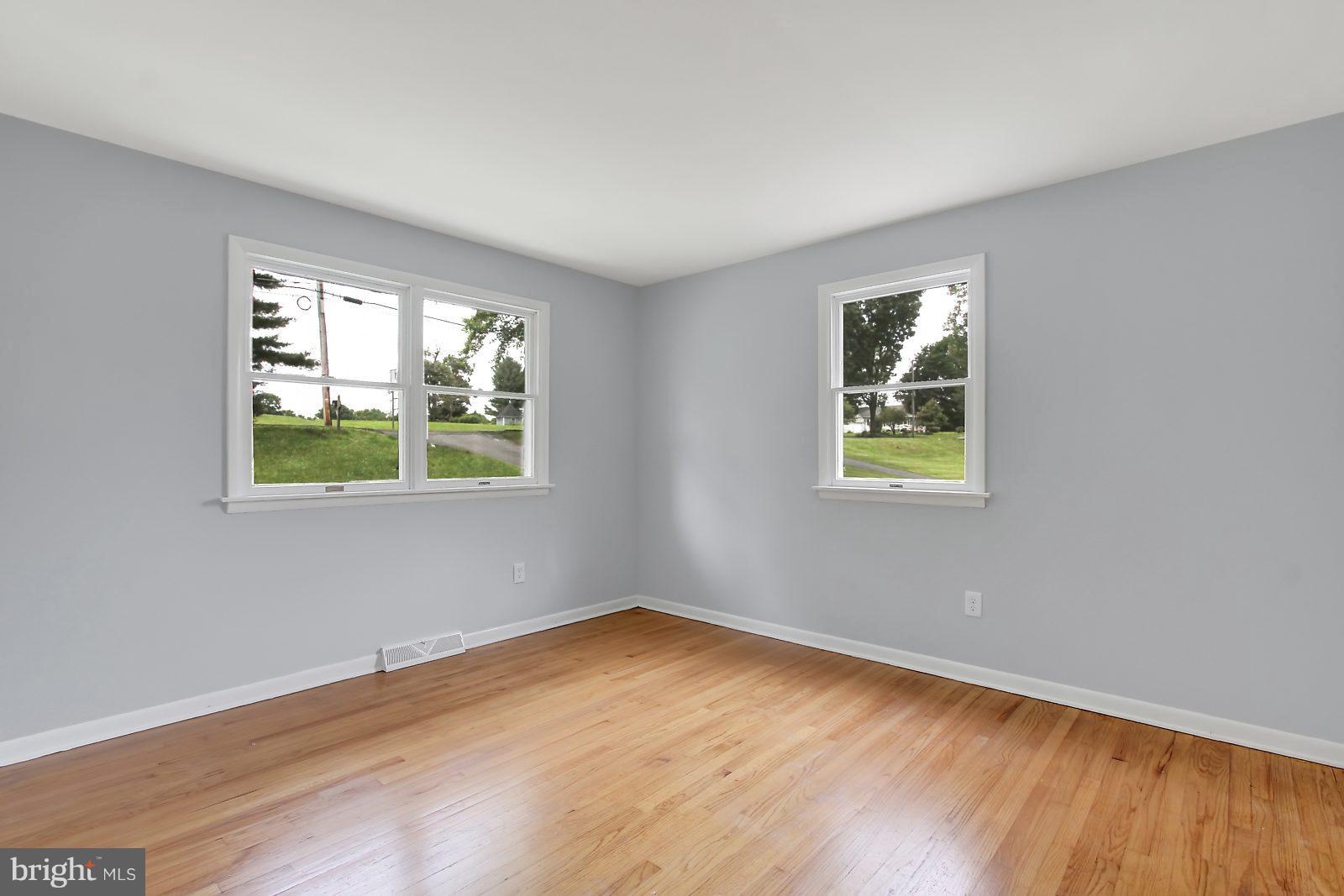 1905 Angleside Road Fallston, MD 21047 - Photo 15 of 25 a view of an empty room with wooden floor and a window