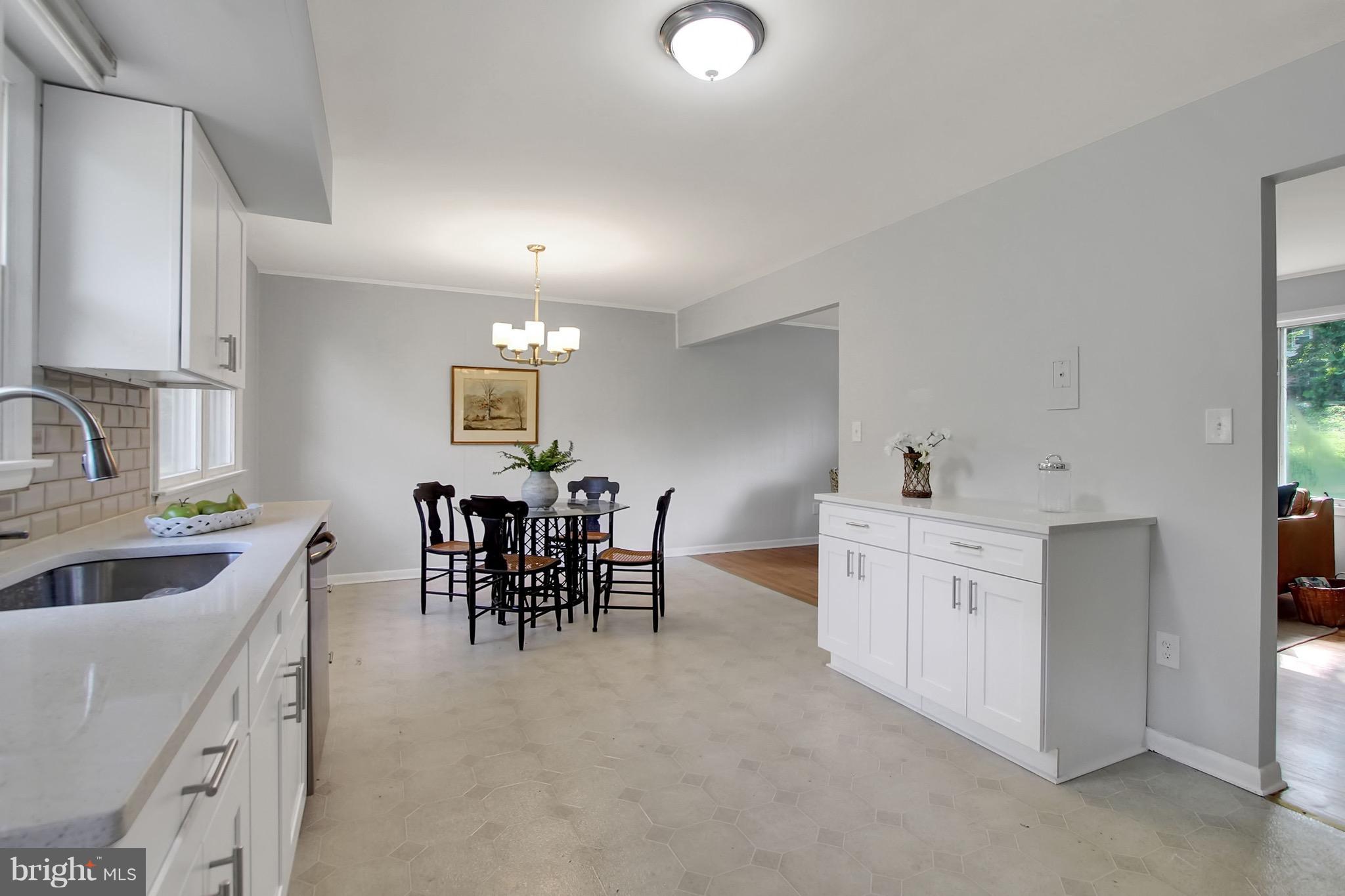 1905 Angleside Road Fallston, MD 21047 - Photo 6 of 25 a kitchen with white cabinets and chairs