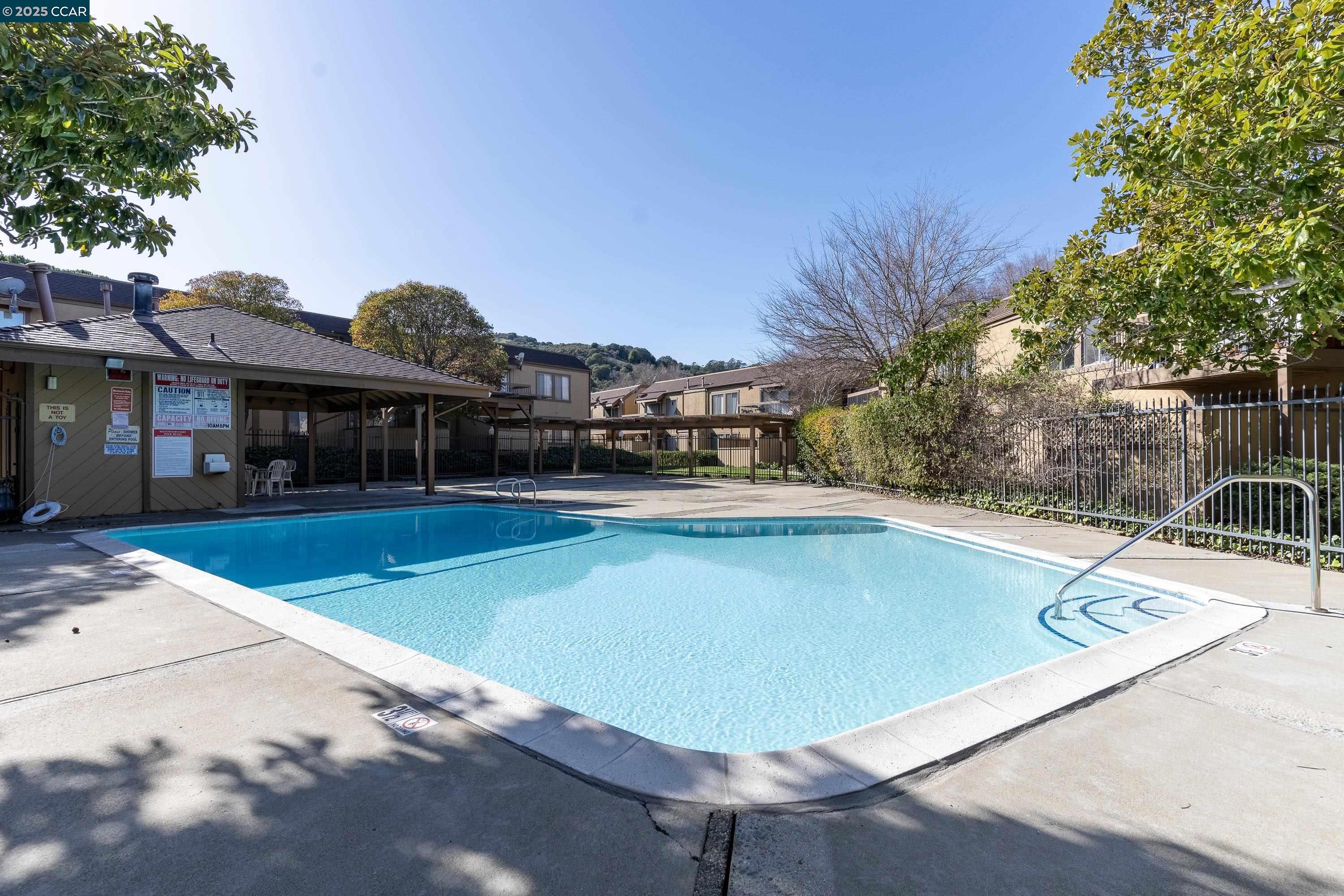 5305 Ridgeview Circle, Unit 8 El Sobrante, CA 94803 - Photo 13 of 18 a view of a swimming pool with a lounge chairs