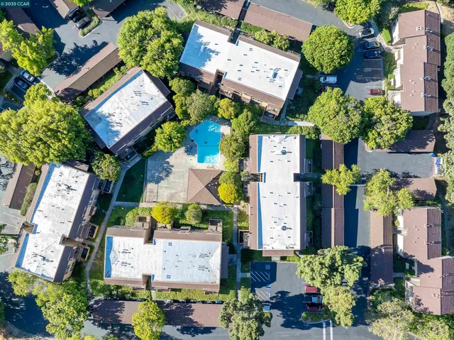 an aerial view of residential house with outdoor space and swimming pool