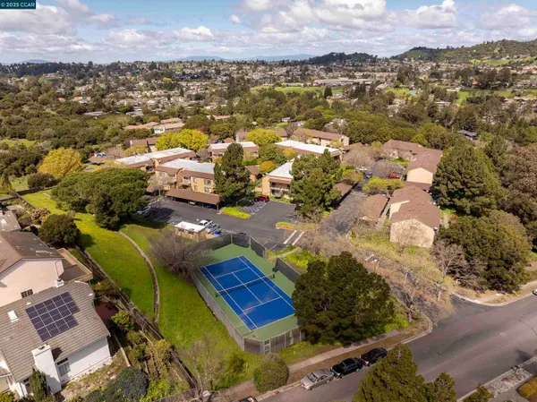 an aerial view of residential houses with outdoor space