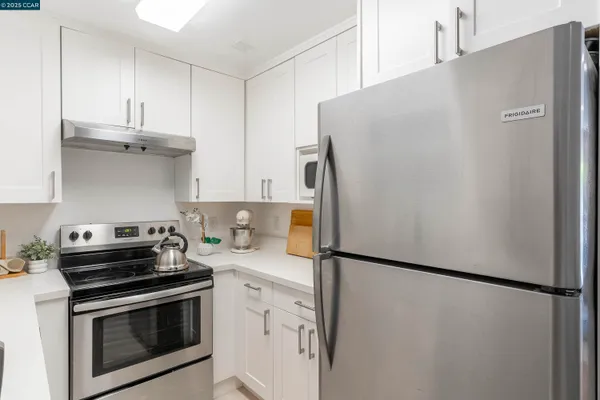 a kitchen with stainless steel appliances a refrigerator a stove and a sink