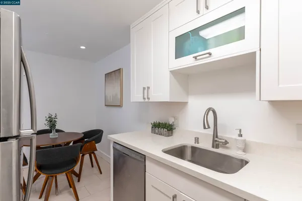 a kitchen with a sink cabinets and appliances