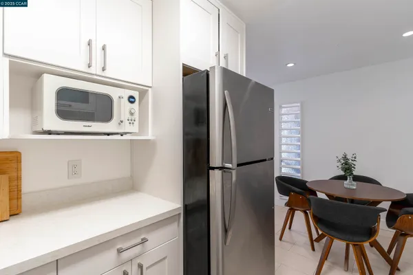 a kitchen with a refrigerator a stove and a microwave