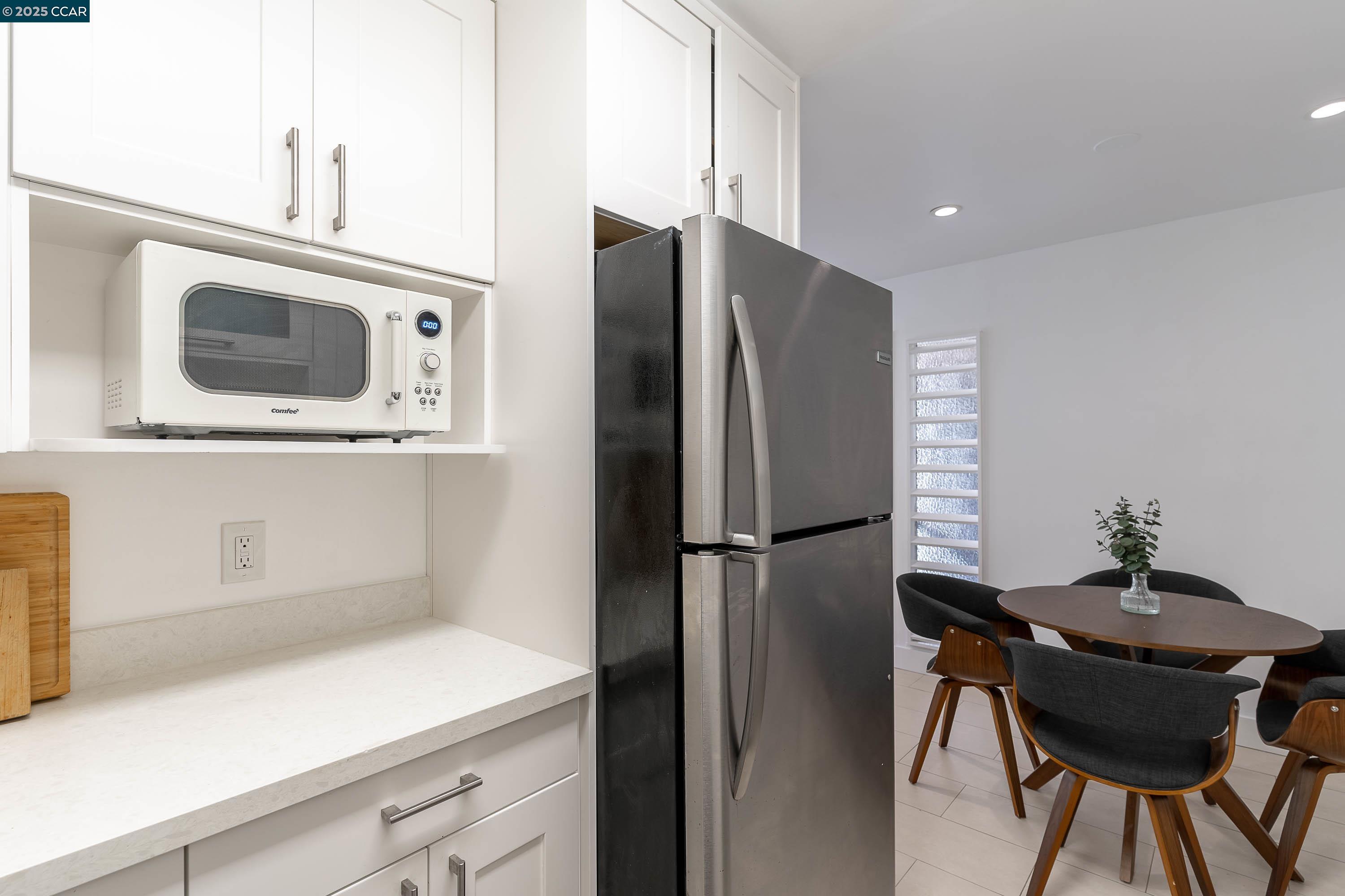 5305 Ridgeview Circle, Unit 8 El Sobrante, CA 94803 - Photo 7 of 18 a kitchen with a refrigerator a stove and a microwave