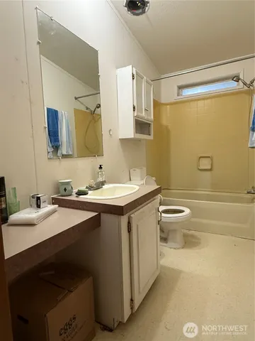 a bathroom with a double vanity sink toilet and mirror
