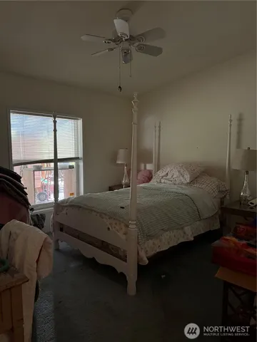 a bedroom with a bed a window and couch