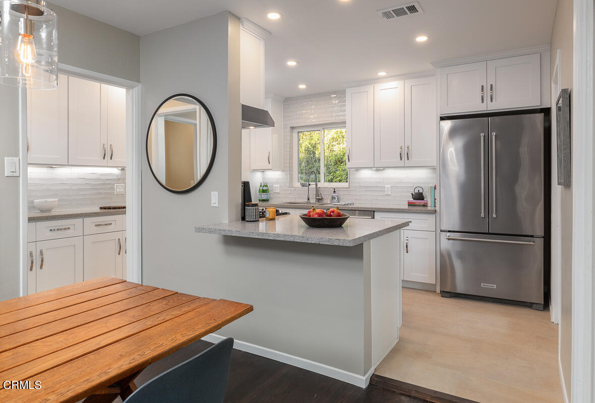 1376 Brixton Road Pasadena, CA 91105 - Photo 12 of 38 a kitchen with stainless steel appliances a refrigerator sink and cabinets