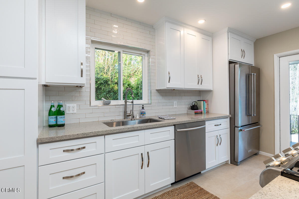 1376 Brixton Road Pasadena, CA 91105 - Photo 13 of 38 a kitchen with stainless steel appliances granite countertop white cabinets a refrigerator a sink a stove a counter space and cabinets