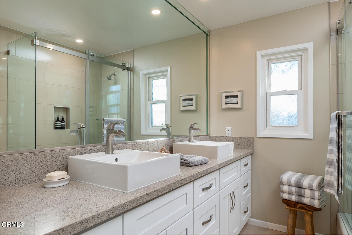 1376 Brixton Road Pasadena, CA 91105 - Photo 22 of 38 a bathroom with double vanity sinks and a mirror