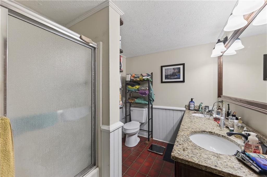 4399 Highway 411 Rydal, GA 30171 - Photo 11 of 37 a bathroom with a granite countertop sink a toilet and shower