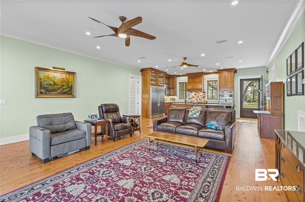 2730 Gator Road Mobile, AL 36605 - Photo 13 of 42 Living room with light wood-style flooring, crown molding, a ceiling fan, and recessed lighting