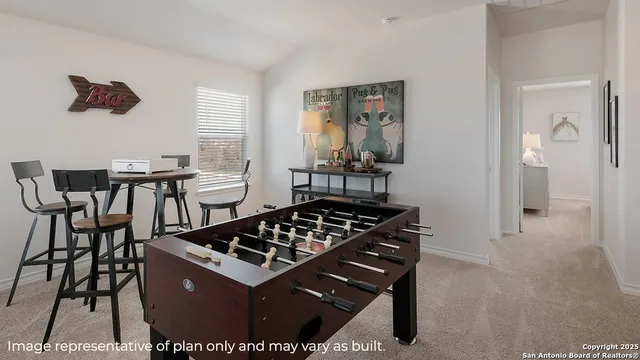 a kitchen with a stove and a dining table