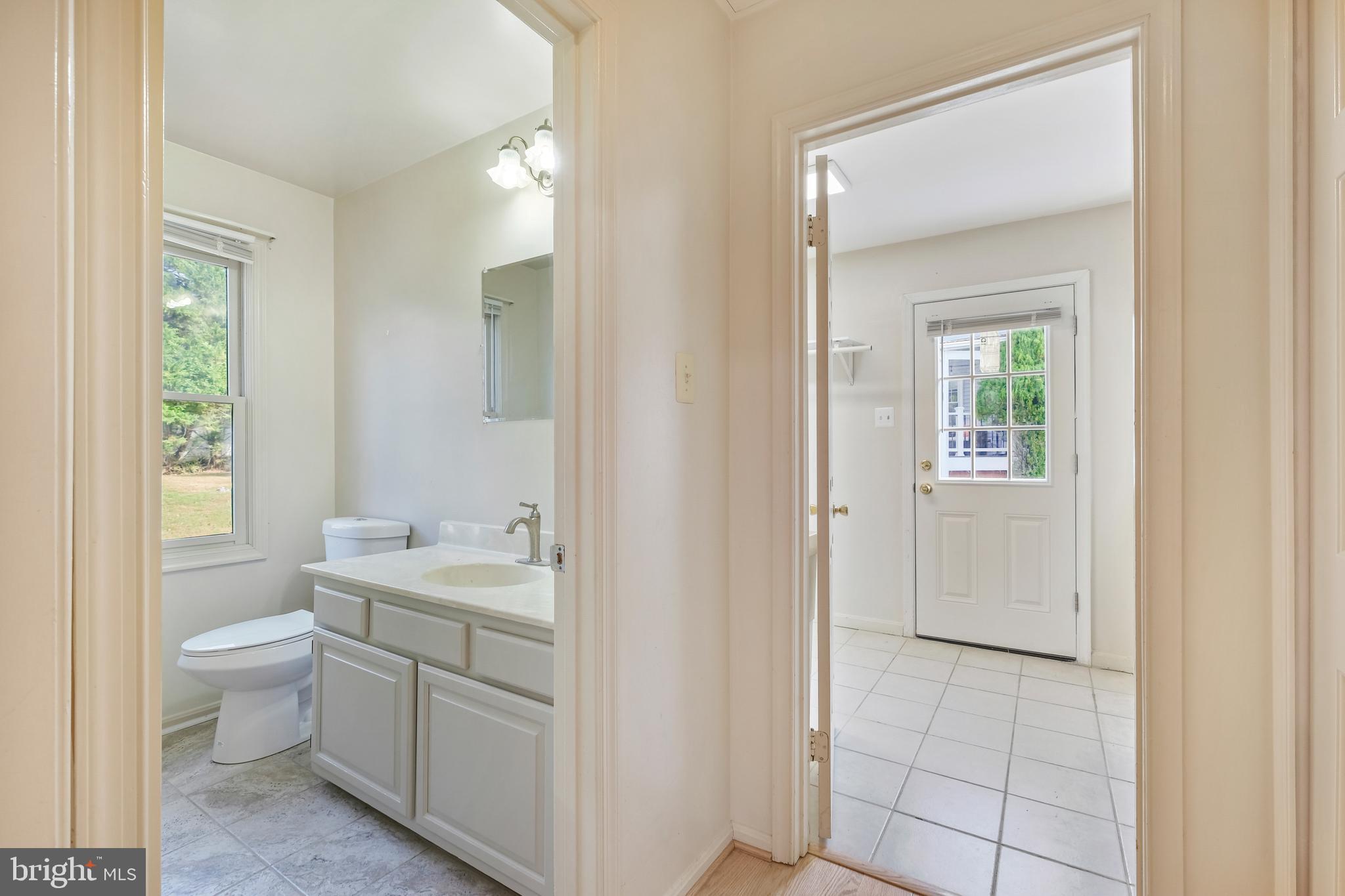 13905 Huxley Cove Court Silver Spring, MD 20906 - Photo 11 of 30 a bathroom with a toilet a sink and a mirror