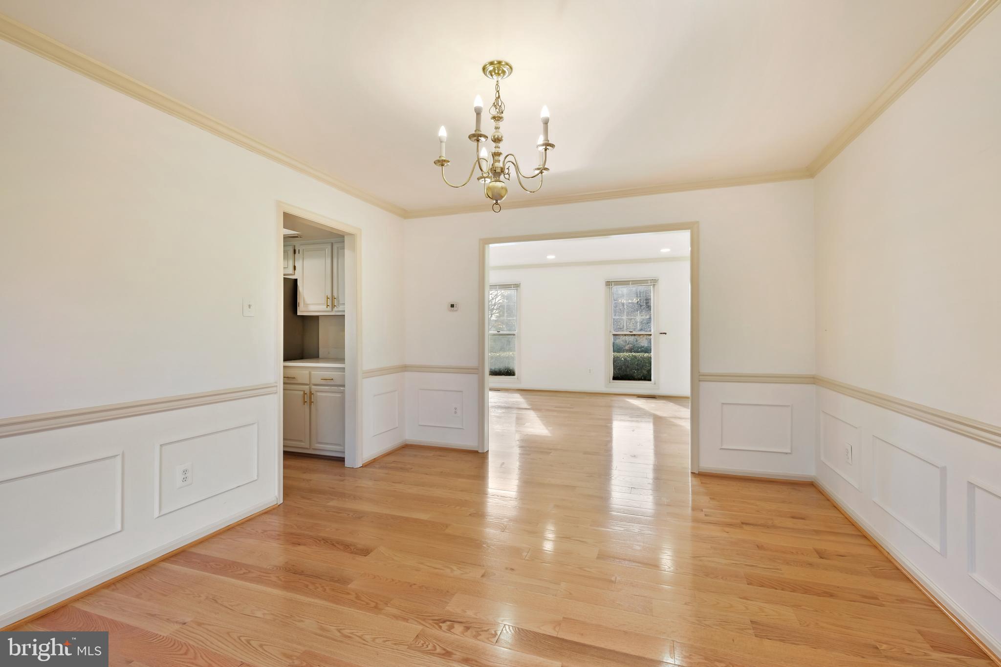 13905 Huxley Cove Court Silver Spring, MD 20906 - Photo 12 of 30 a view of a hallway with wooden floor and a kitchen