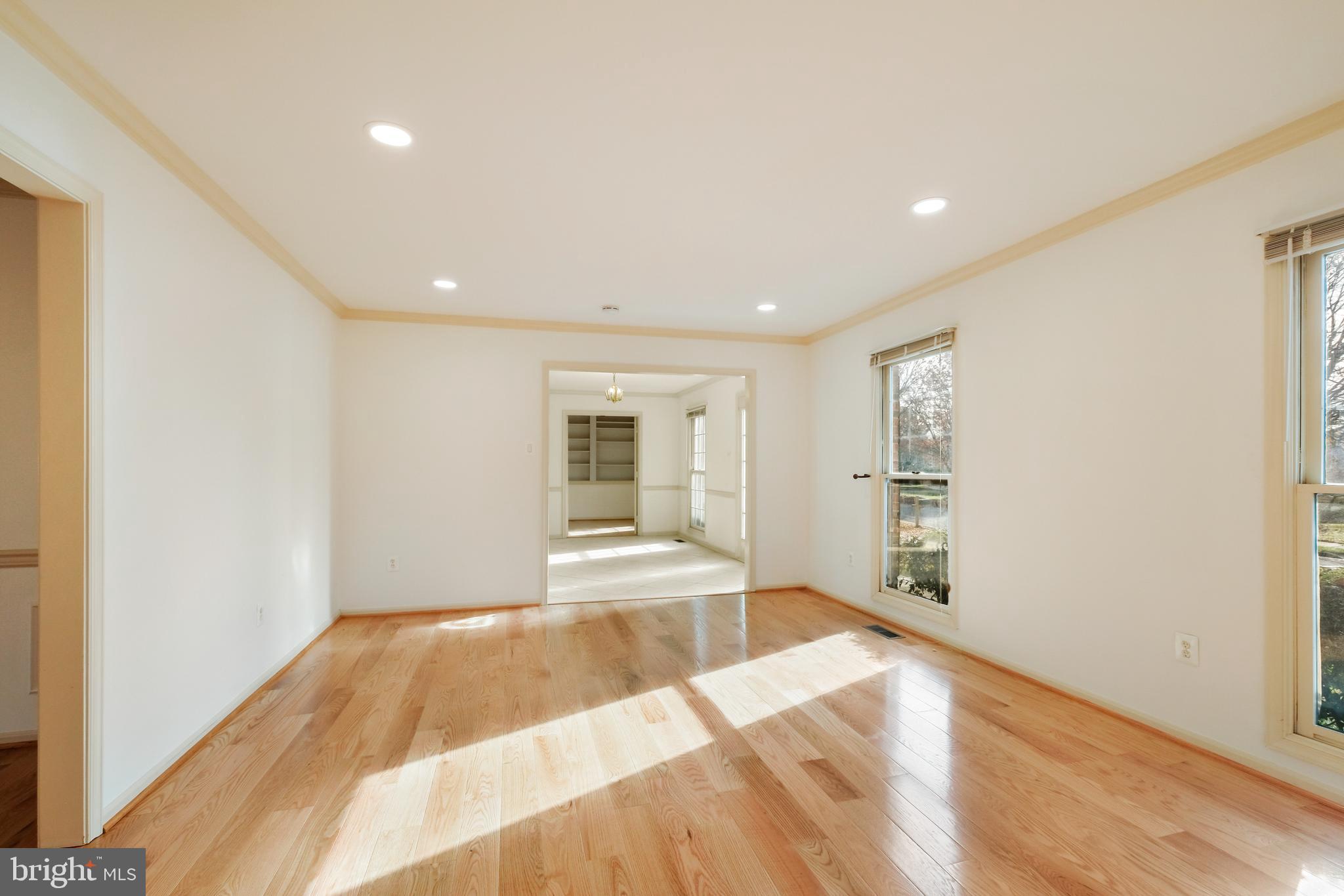 13905 Huxley Cove Court Silver Spring, MD 20906 - Photo 16 of 30 a view of an empty room with wooden floor and a window