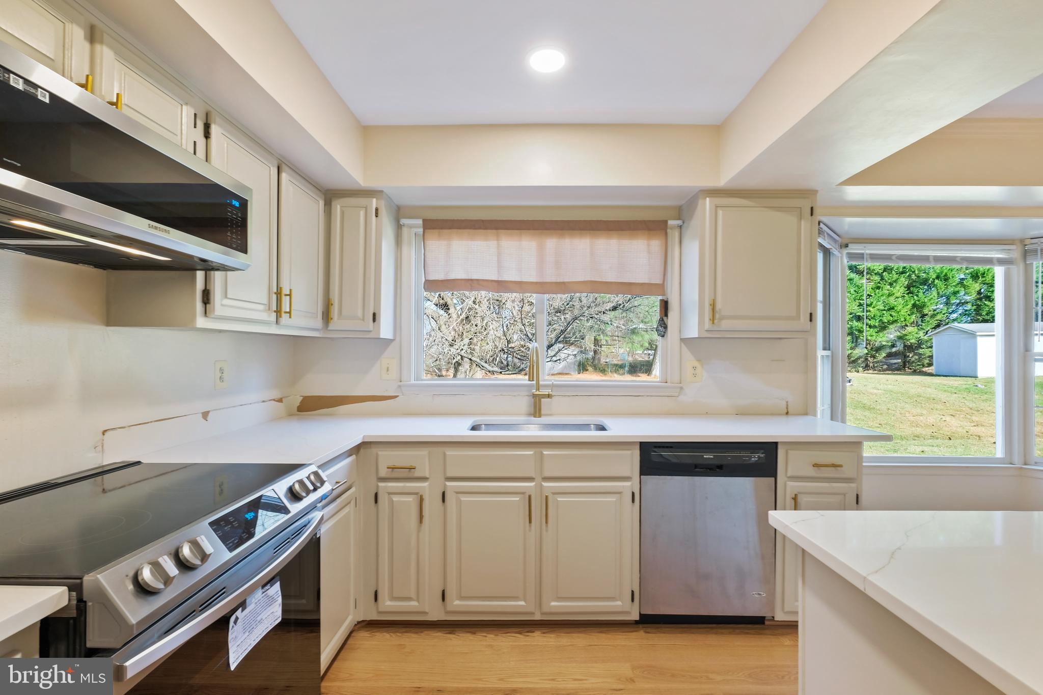 13905 Huxley Cove Court Silver Spring, MD 20906 - Photo 7 of 30 a kitchen with a sink stove top oven and cabinets