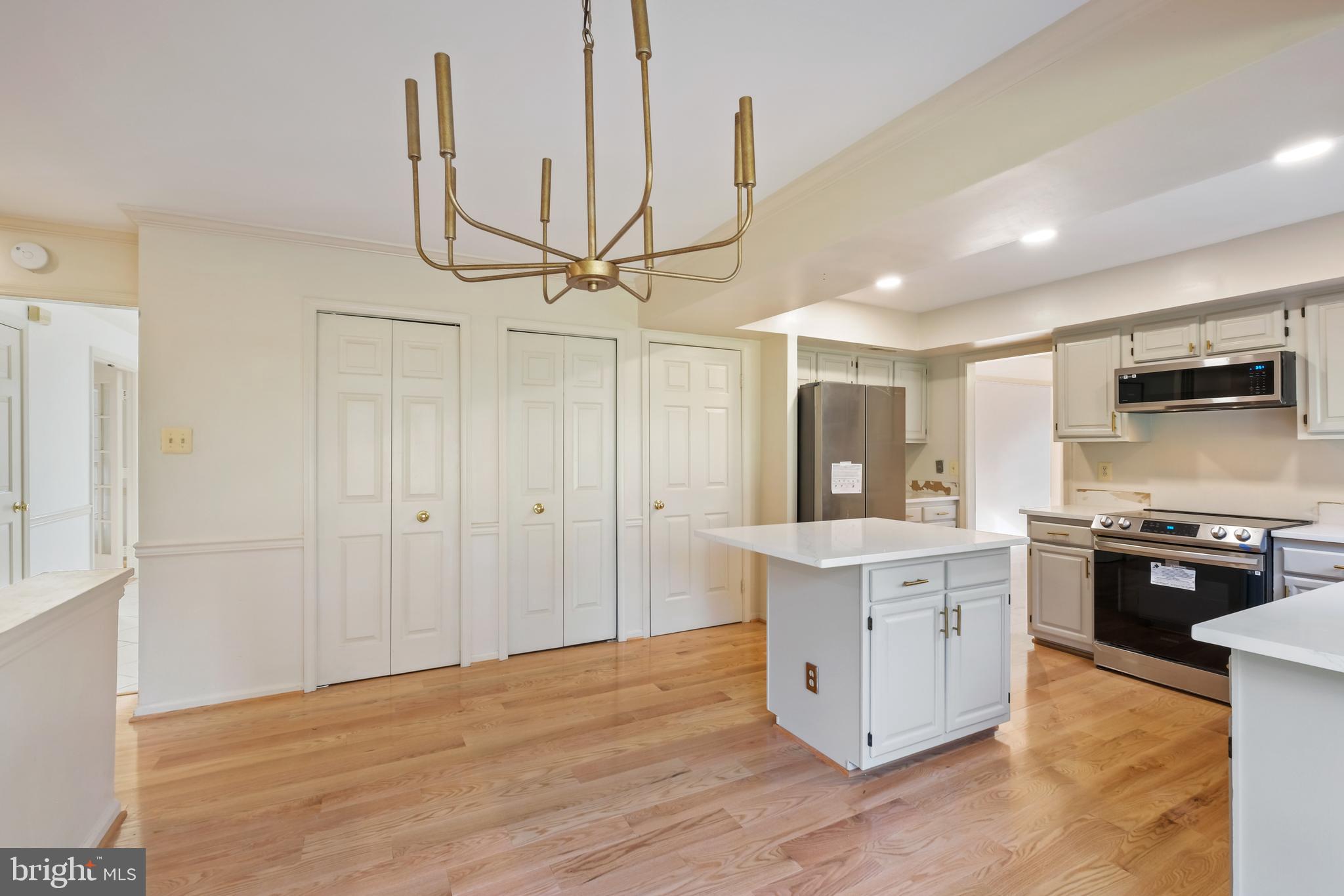 13905 Huxley Cove Court Silver Spring, MD 20906 - Photo 8 of 30 a large kitchen with stainless steel appliances granite countertop a stove and a sink