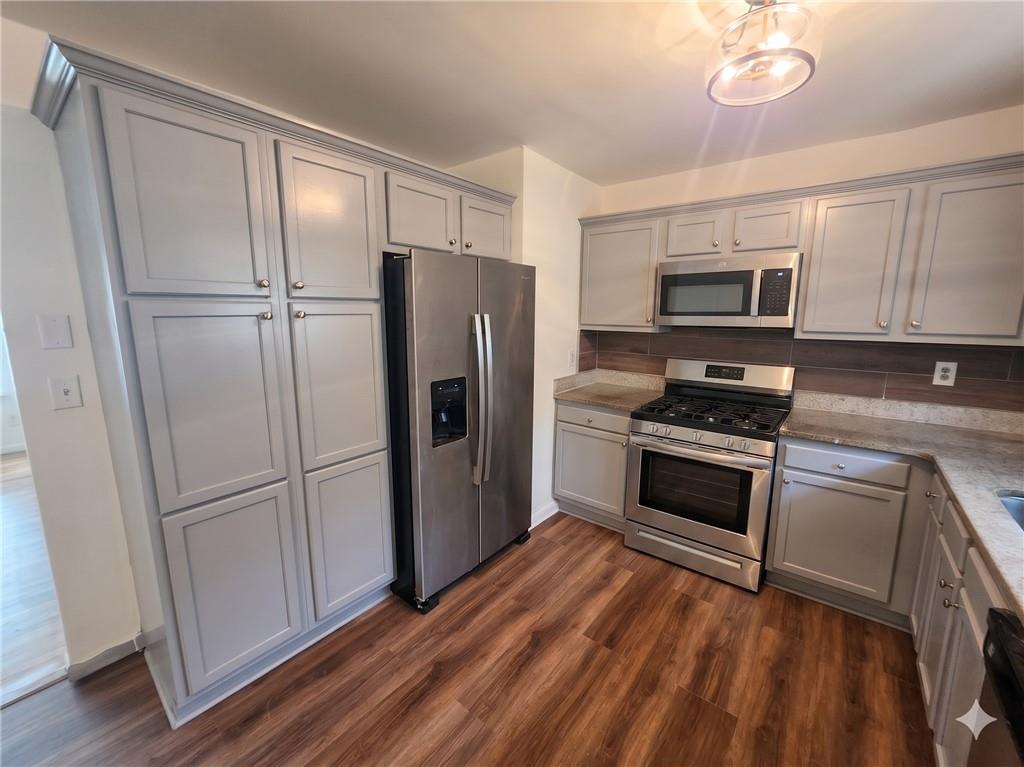 1929 Wee Kirk Road Southeast Atlanta, GA 30316 - Photo 7 of 22 a kitchen with granite countertop a refrigerator stove and sink