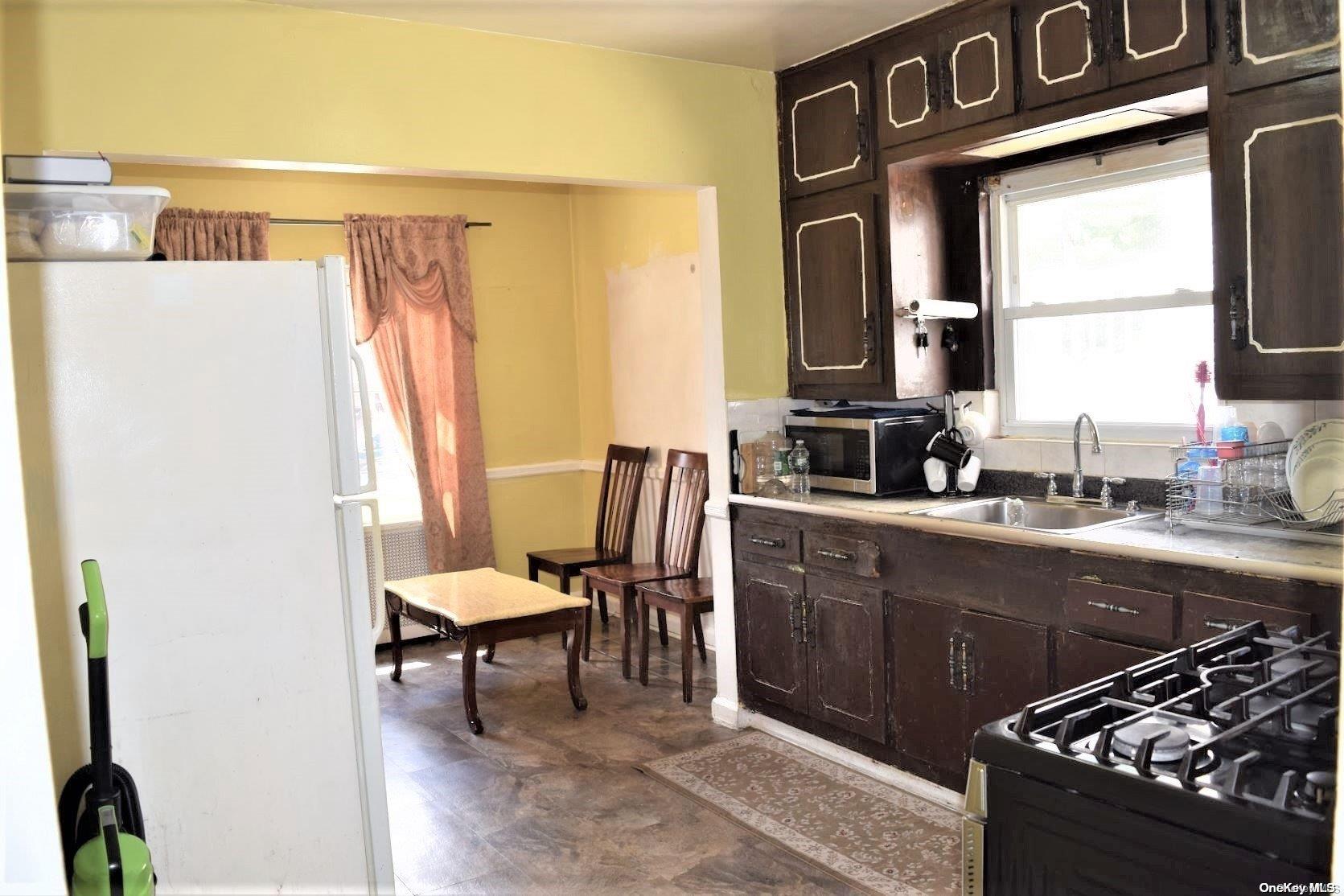 135-11 62nd Road Queens, NY 11367 - Photo 1 of 1 a kitchen with stainless steel appliances granite countertop a sink and a stove