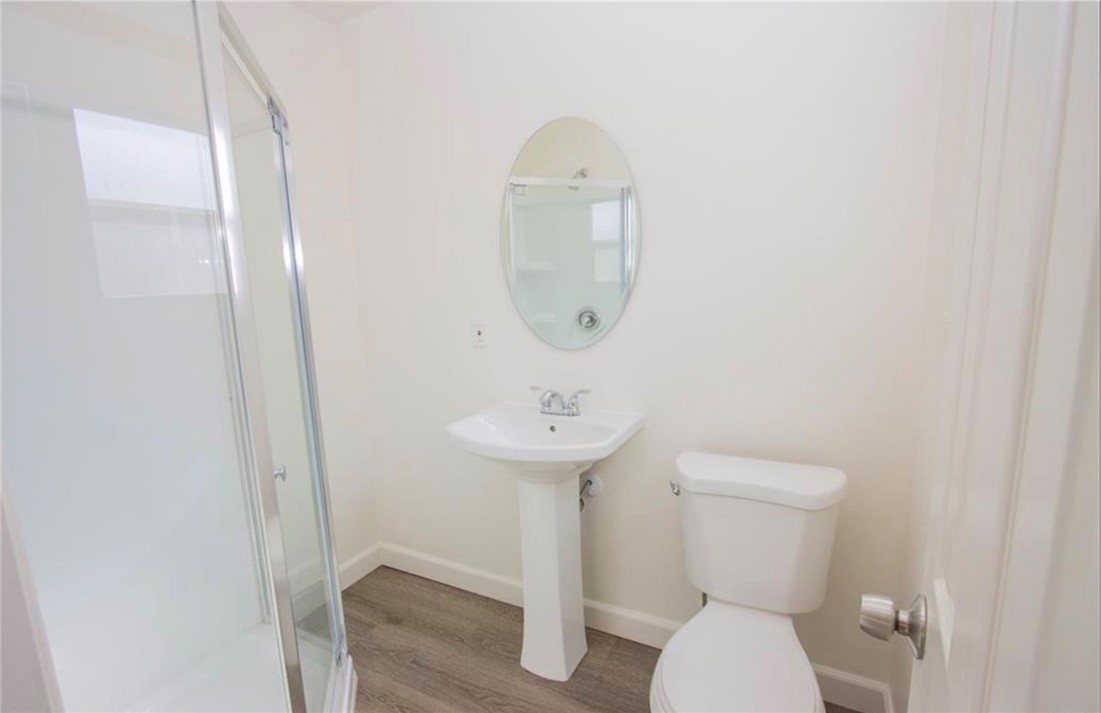 3110 Lime Street Riverside, CA 92501 - Photo 6 of 9 a bathroom with a toilet a sink and mirror