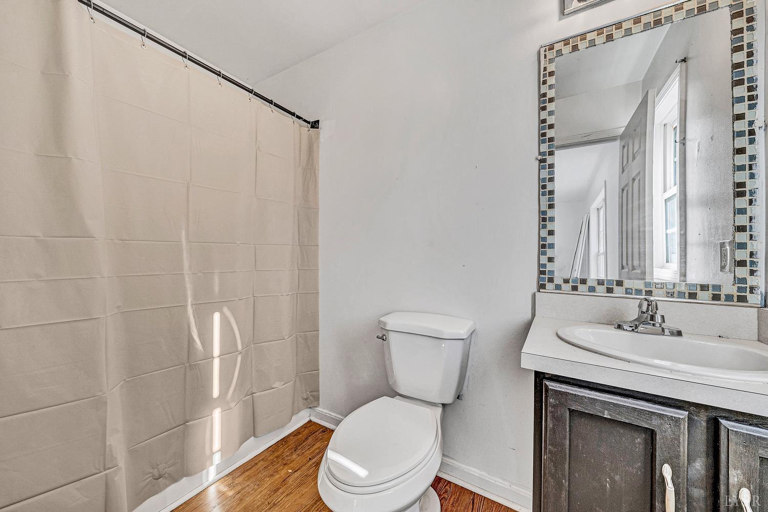 3949 Diamond Hill Road Moneta, VA 24121 - Photo 12 of 30 a bathroom with a sink a toilet and shower