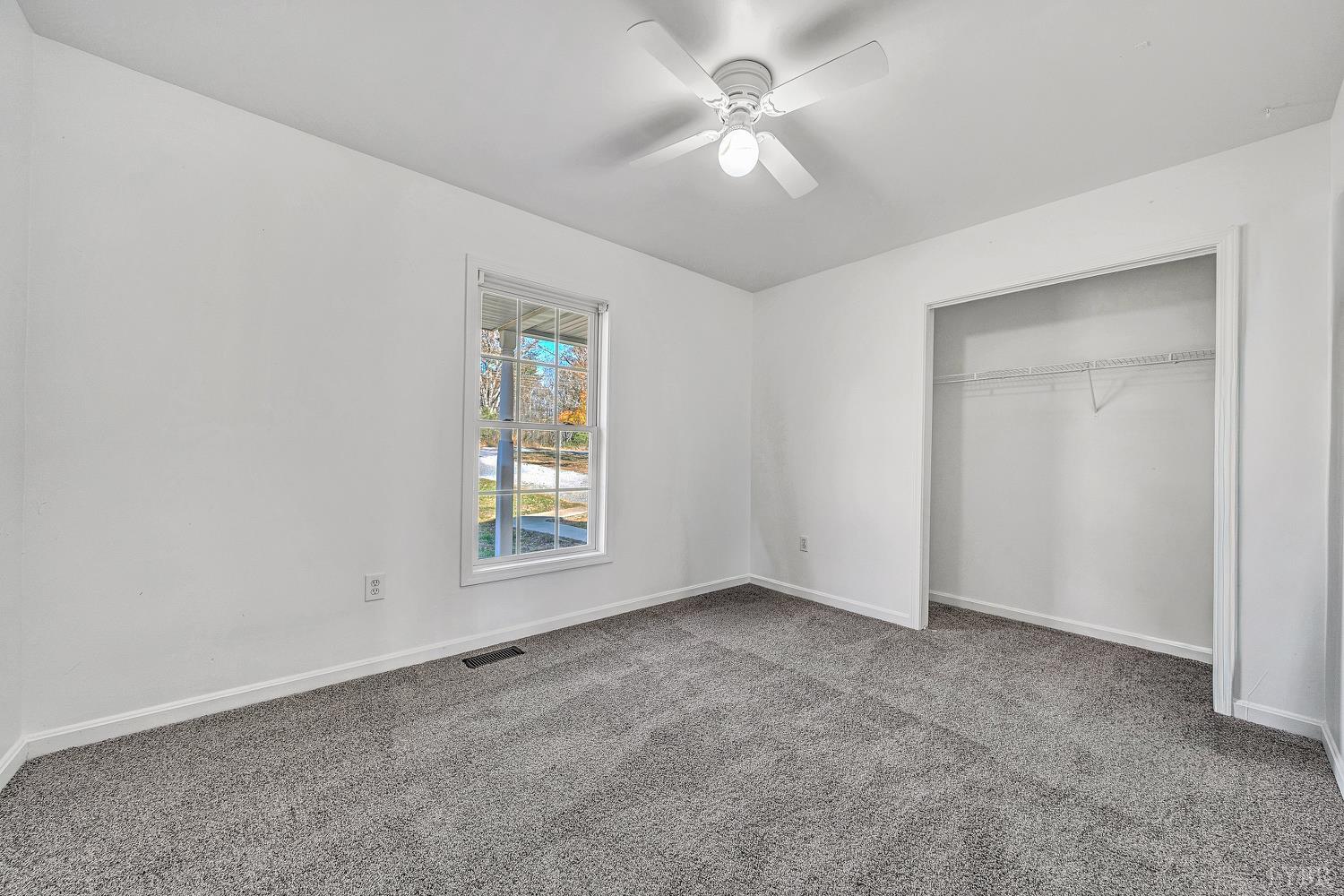 3949 Diamond Hill Road Moneta, VA 24121 - Photo 16 of 30 an empty room with windows and fan